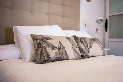 a bed with two pillows on top of it at Casa Cuesta Belén in Arcos de la Frontera