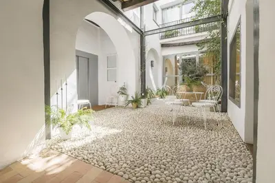 an indoor courtyard with chairs and plants in a building at Mar Abierto B in Sanlúcar de Barrameda