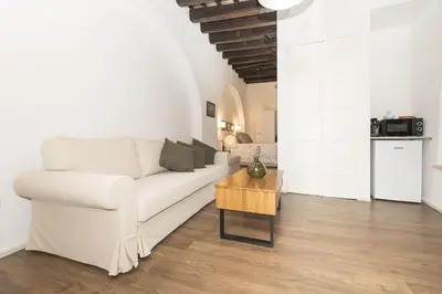 a living room with a white couch and a table at Mar Abierto B in Sanlúcar de Barrameda