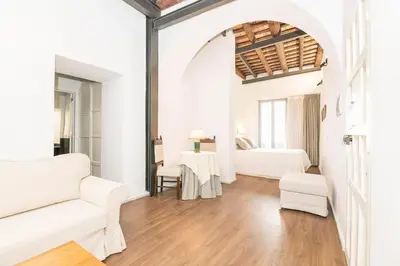 a white room with two beds and a table at Mar Abierto A in Sanlúcar de Barrameda