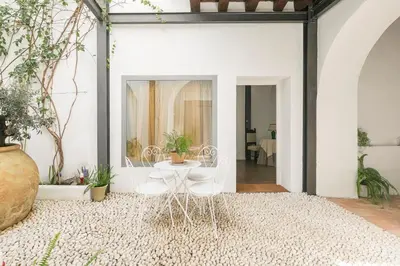 a room with white walls and a table and chairs at Mar Abierto A in Sanlúcar de Barrameda