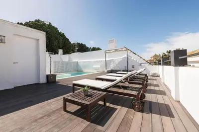 a rooftop deck with lounge chairs and a pool at Mar Abierto A in Sanlúcar de Barrameda