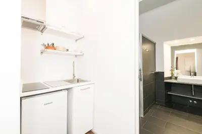 a white bathroom with a sink and a shower at Mar Abierto A in Sanlúcar de Barrameda
