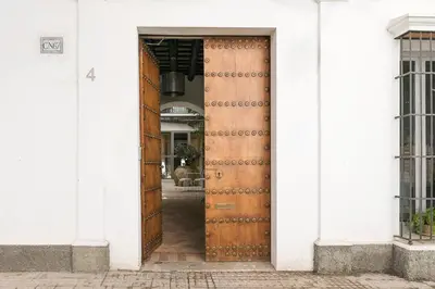a wooden door in a white building at Mar Abierto A in Sanlúcar de Barrameda