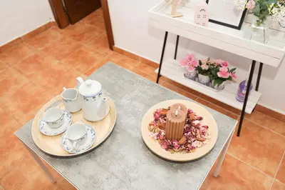 a table with two plates of food and cups on it at Casa Algodon in Chiclana de la Frontera