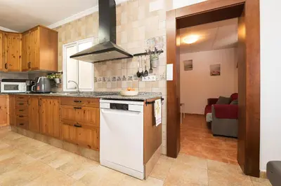 a kitchen with a white stove top oven in a room at Casa Algodon in Chiclana de la Frontera