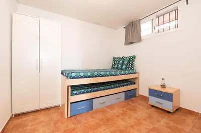 a bedroom with a bunk bed in a room at Casa Algodon in Chiclana de la Frontera