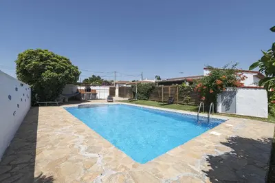 a swimming pool in a yard with a house at Casa Algodon in Chiclana de la Frontera