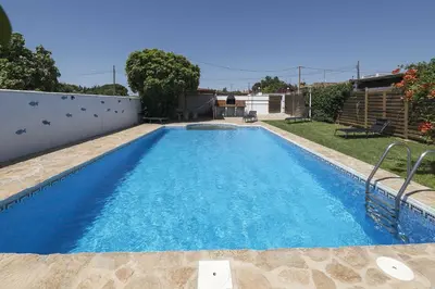 a swimming pool in the backyard of a house at Casa Algodon in Chiclana de la Frontera
