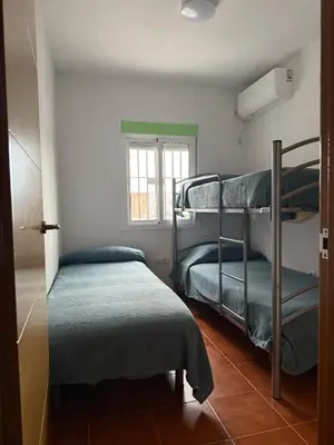 a room with two bunk beds and a window at Dúplex tras Regla in Chipiona