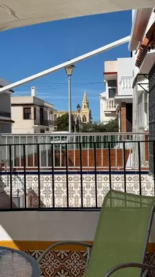 a balcony with a view of a building at Dúplex tras Regla in Chipiona