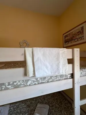 a bunk bed with a towel on it in a room at Villa Serena in Chiclana de la Frontera