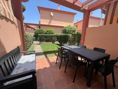 a patio with a table and chairs on a patio at Villa Serena in Chiclana de la Frontera