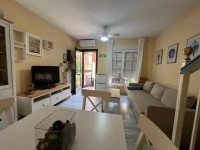 a living room with a couch and a table at Villa Serena in Chiclana de la Frontera
