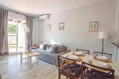 a living room with a couch and a table at Brisa del Mar II, Apartamentos Living Sur in Sanlúcar de Barrameda