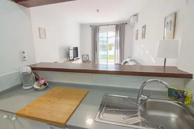 a kitchen with a sink and a counter top at Brisa del Mar II, Apartamentos Living Sur in Sanlúcar de Barrameda