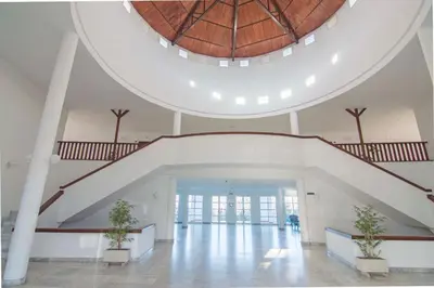 an open staircase in a building with two potted plants at Brisa del Mar II, Apartamentos Living Sur in Sanlúcar de Barrameda