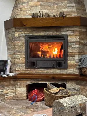 a fireplace with a fire burning in it at OHANA home in Conil de la Frontera