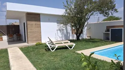 a yard with a chair and a swimming pool at PASSIVE HOUSE in Novo Sancti Petri