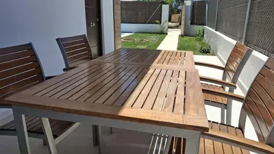 a wooden table and chairs on a patio at PASSIVE HOUSE in Novo Sancti Petri