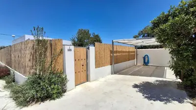 a garage with a gate and a fence at PASSIVE HOUSE in Novo Sancti Petri