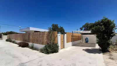 a house with a fence and a gate at PASSIVE HOUSE in Novo Sancti Petri