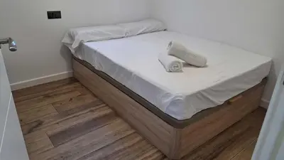 a bed with white sheets and two pillows on it at PASSIVE HOUSE in Novo Sancti Petri