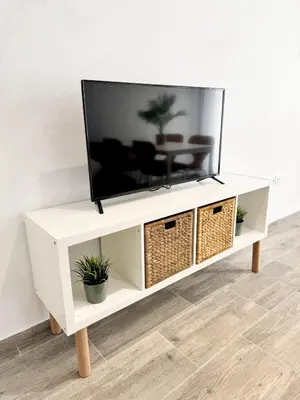a white entertainment center with a flat screen tv on top at Apartamento La Sal Centro in San Fernando