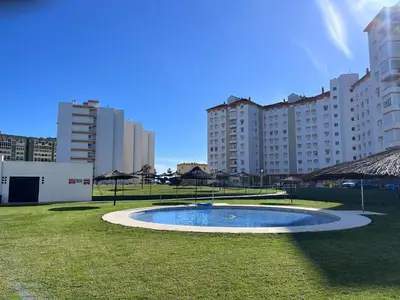 a small pool in the middle of a park with tall buildings at GATU Villa Flavia 