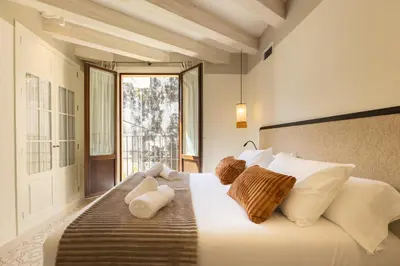 two beds sitting next to each other in a room at Aladro Apartamentos by Valcambre in Jerez de la Frontera