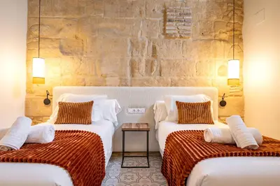 a living room with a couch and a table at Aladro Apartamentos by Valcambre in Jerez de la Frontera
