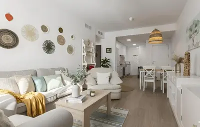 a living room with a couch and a table at Chic & Bright Costa Ballena Getaway in Chipiona