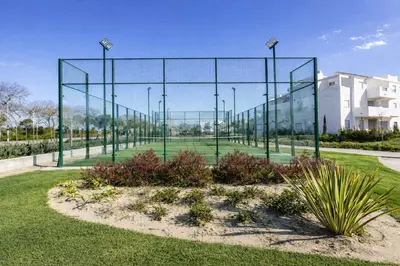 a large glass fence in the middle of a park at Chic & Bright Costa Ballena Getaway in Chipiona