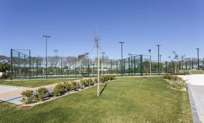 a park with a tree in the grass at Chic & Bright Costa Ballena Getaway in Chipiona