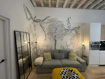 a living room with a couch and a painting on the wall at Cádiz Paz in Cádiz