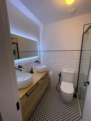 a bathroom with two sinks and a mirror at Cádiz Paz in Cádiz