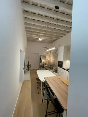 a kitchen and living room with a table and chairs at Cádiz Paz in Cádiz