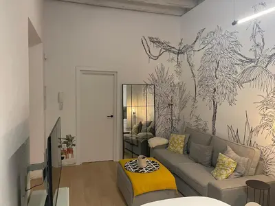 a living room with a couch and a wall mural at Cádiz Paz in Cádiz