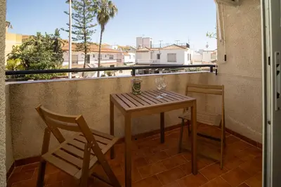 a table and chairs on a balcony with a view at SIBS Sanlúcar Camelias-Ideal Familias Cerca Playa in Sanlúcar de Barrameda