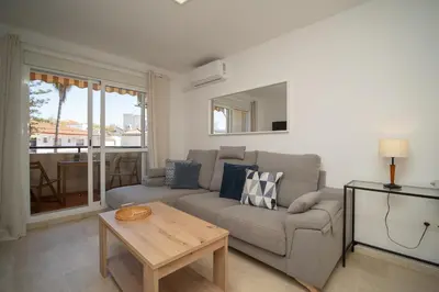 a living room with a couch and a table at SIBS Sanlúcar Camelias-Ideal Familias Cerca Playa in Sanlúcar de Barrameda