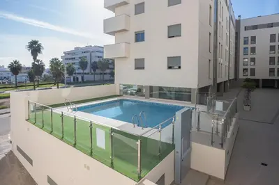 a swimming pool on the balcony of a building at Acogedor apartamento céntrico in El Puerto de Santa María