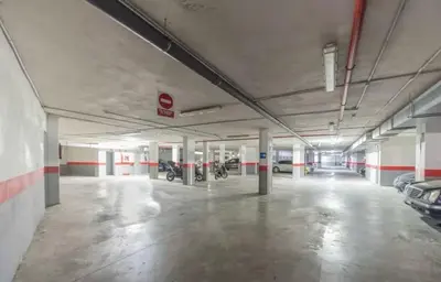 an empty parking garage with motorcycles parked in it at Acogedor apartamento céntrico in El Puerto de Santa María