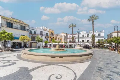 a fountain in the middle of a city street at Plaza del Cabildo Sanlucar Center by Valcambre in Sanlúcar de Barrameda