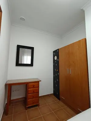 a room with a desk and a wooden cabinet at El balconcito in Arcos de la Frontera