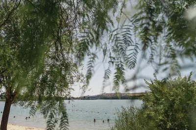 a view of a lake with people in the water at El balconcito in Arcos de la Frontera