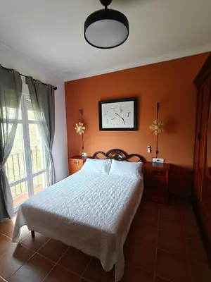 a bedroom with a large bed and a window at El balconcito in Arcos de la Frontera