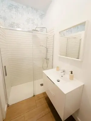 a bathroom with a white sink and a shower at Gallery Vistahermosa in El Puerto de Santa María