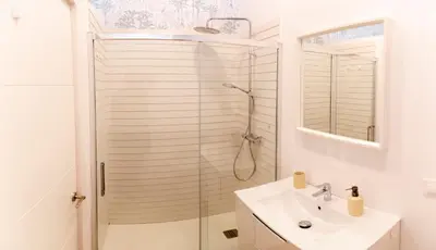 a white bathroom with a shower and a sink at Gallery Vistahermosa in El Puerto de Santa María