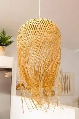 a gold pendant light hanging from a ceiling at Gallery Vistahermosa in El Puerto de Santa María