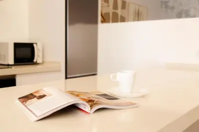 an open book on a counter with a cup of coffee at Gallery Vistahermosa in El Puerto de Santa María